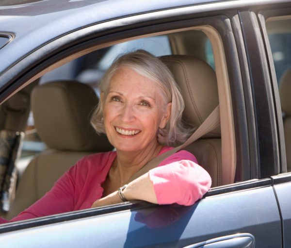 Senior woman behind the wheel of her car