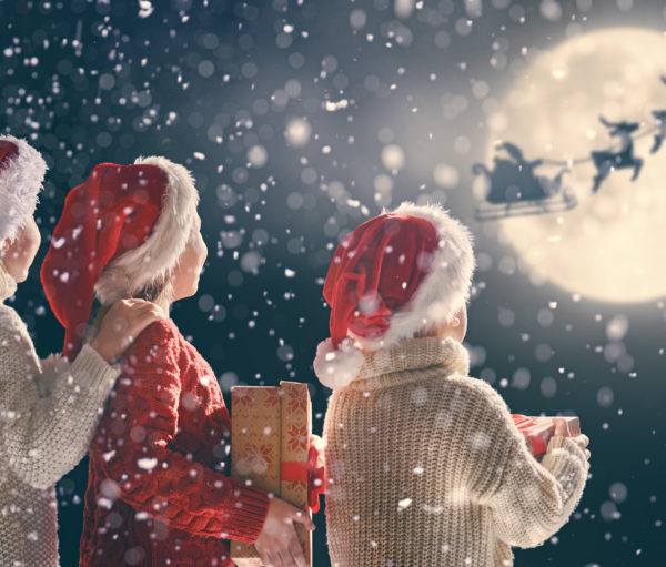 Three children dressed in Santa